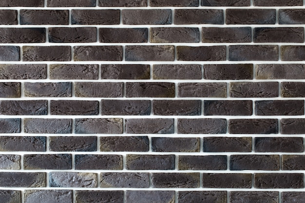 Free photo dark brown brick wall