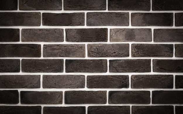 Free photo dark brown brick wall