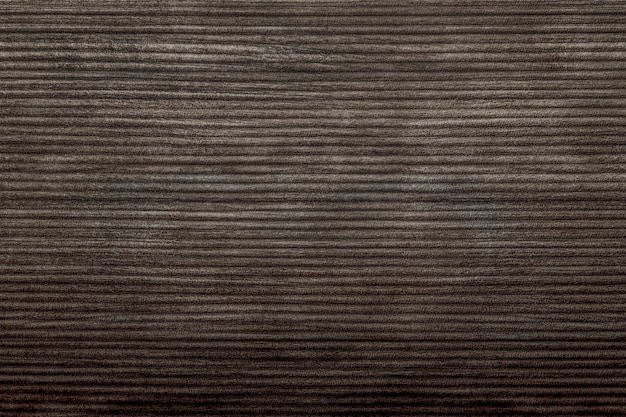 Dark brown corduroy fabric textured background