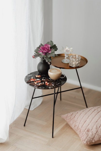 Free Photo dark chocolate brittle and milk tea on a black table with an ornamental kale flower