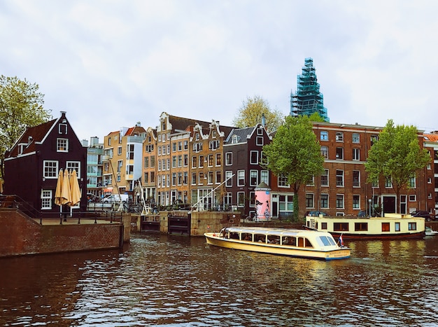 Free photo dark clouds over canal in amsterdam