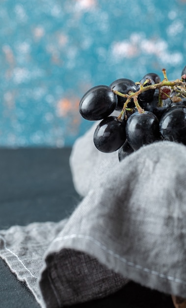 Dark fresh grape in basket on a colorful