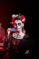 Free photo dark lady using debit card to pay during dia de los muertos