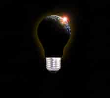 Free photo dark planet earth in a lightbulb