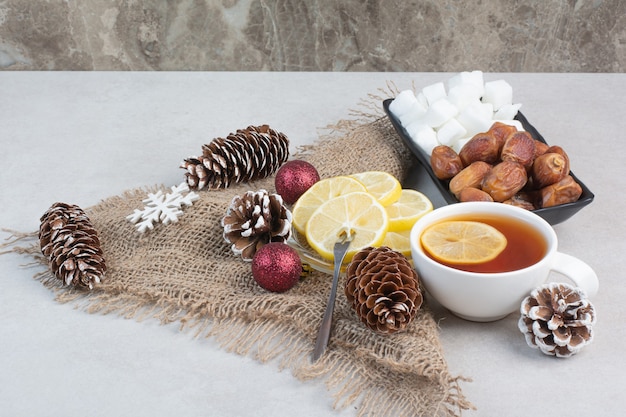 A dark plate of loafsugar and dried fruit on white background. High quality photo