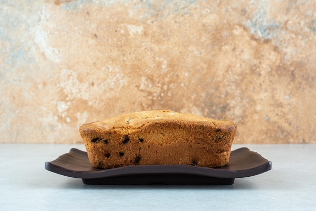 A dark plate with delicious fresh cake on white