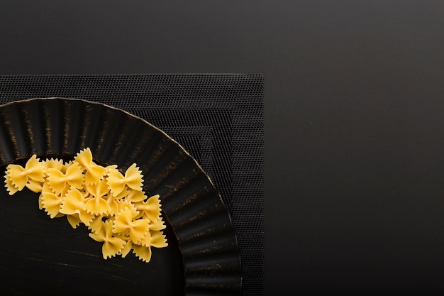 Free Photo dark plate with pasta on a dark cloth