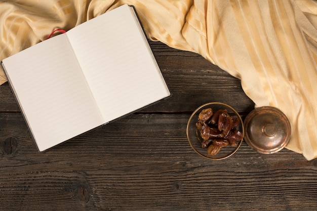 Free photo dates fruit in bowl with blank notebook