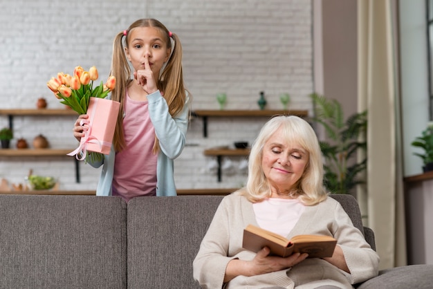 Daughter asks for silence with finger on lips