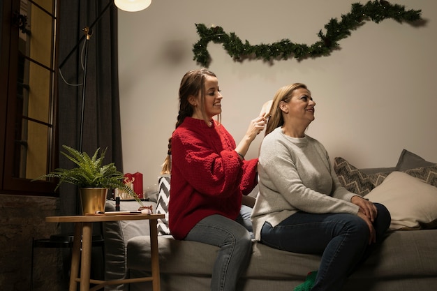 Free photo daughter brushing her mothers hair