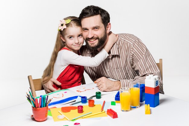 daughter and father drawing together