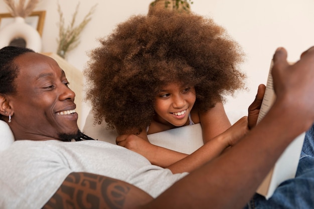 Daughter and father relaxing at home