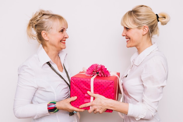 Daughter giving mother a present