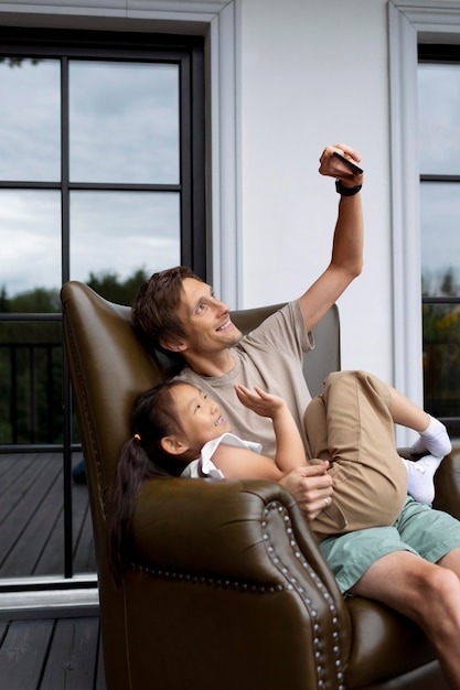 Free photo daughter having a video call with her mom next to her dad