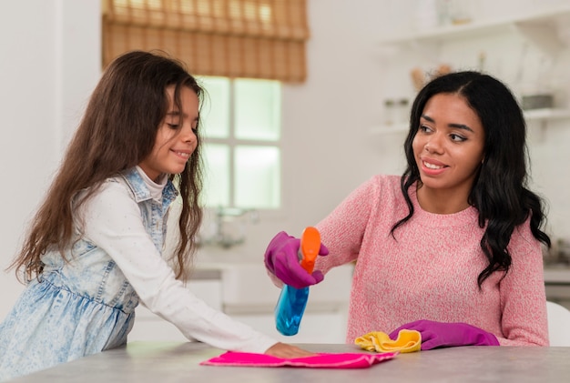 Daughter helping mom to clean