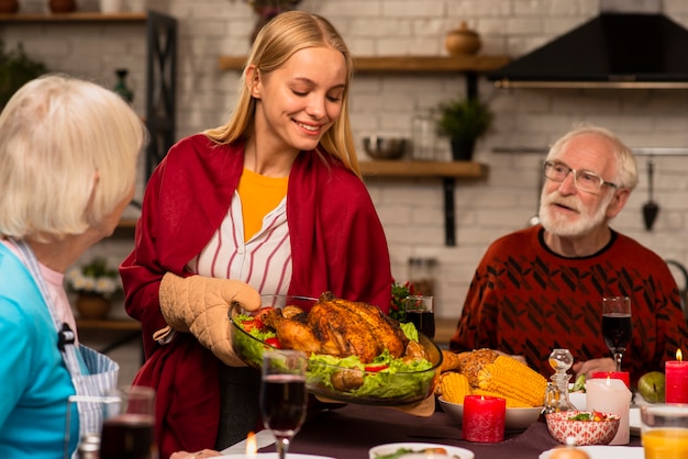 Free Photo daughter is bringing the delicious turkey at the table