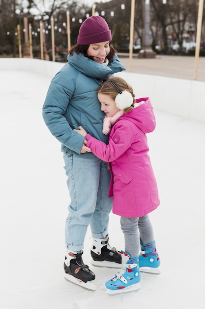 Free photo daughter and mom hugging outdoors