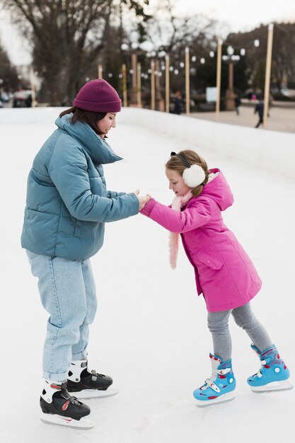 Daughter and mom ice skating together