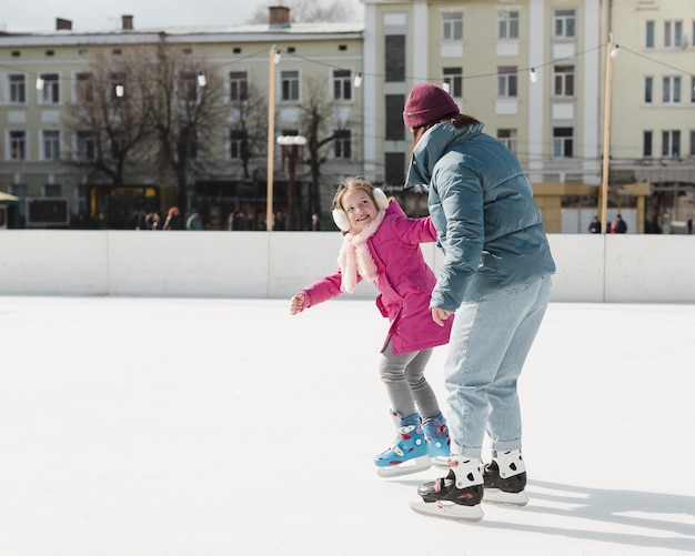 Daughter and mom ice skating together