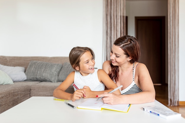 Daughter and mother doing homework together