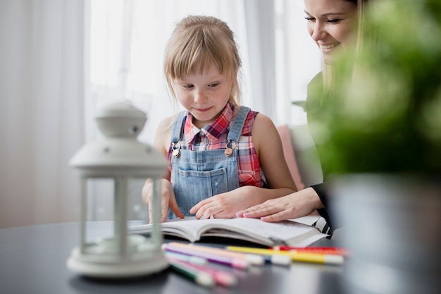 Free Photo daughter studying with mother