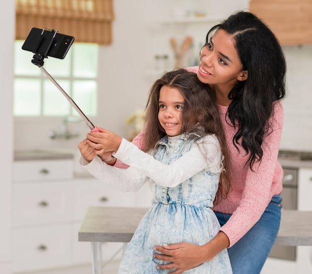 Free photo daughter taking selfie with mom