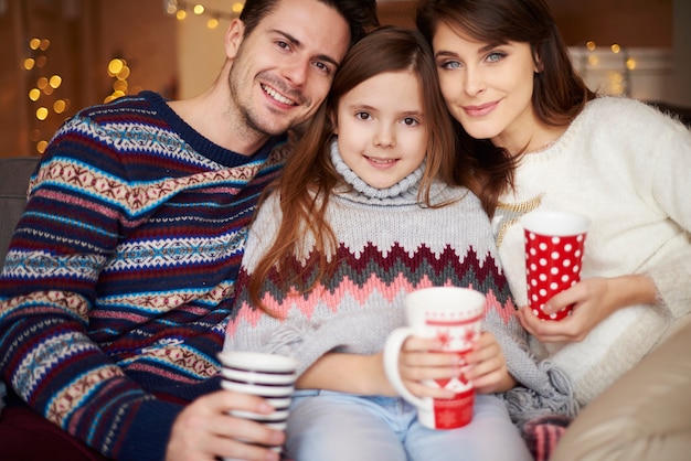 Daughter with parents posing in front of camera