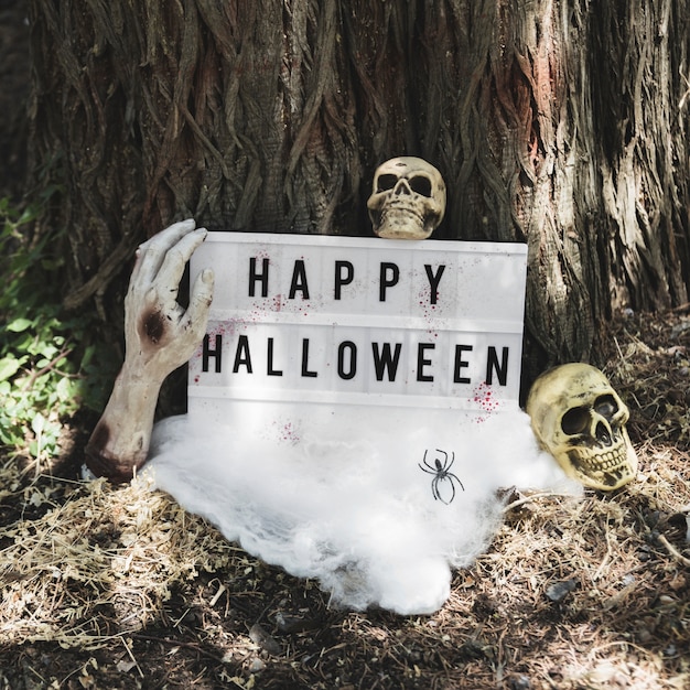 Free photo dead hand holding halloween tablet