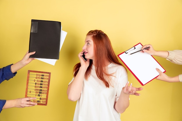 Free photo deadline. caucasian young woman's portrait on yellow studio background, too much tasks. how to manage time right. concept of office working, business, finance, freelance, self management, planning.