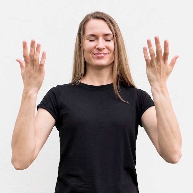 Free photo deaf woman communicating through sign language