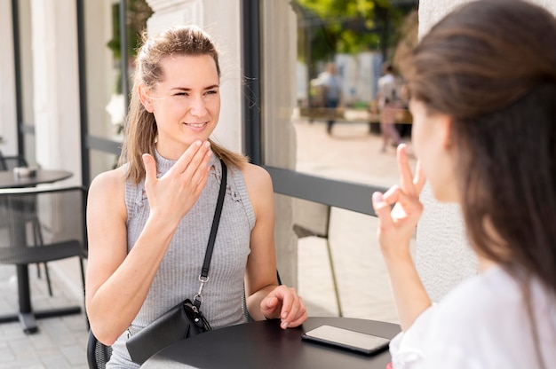 Deaf women communicating through sign language