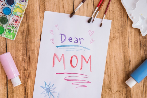 Free photo dear mom inscription on paper with paints