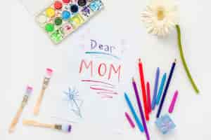 Free photo dear mom inscription on paper with pencils