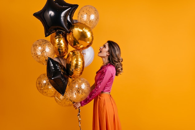 Debonair woman looking at party balloons