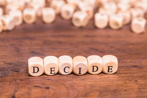 Free photo decide text written on wooden dice