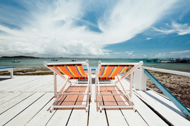 Free photo deckchair at coast of sea