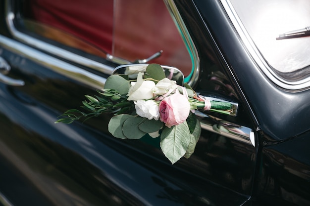 The decor of a wedding car with flowers