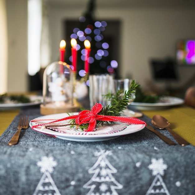 Decorated plate on Christmas tablecloth