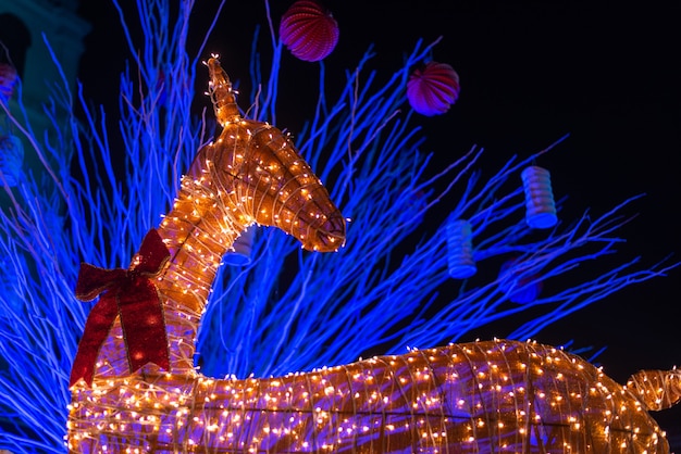 Free photo decorated reindeer installation illuminated with lights during christmas