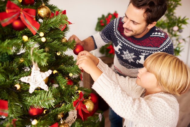 Decorating Christmas tree with daddy