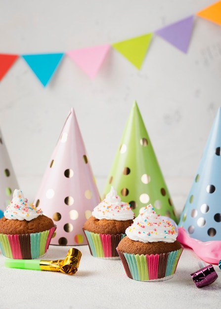 Free photo decoration with glazed muffins and party hats