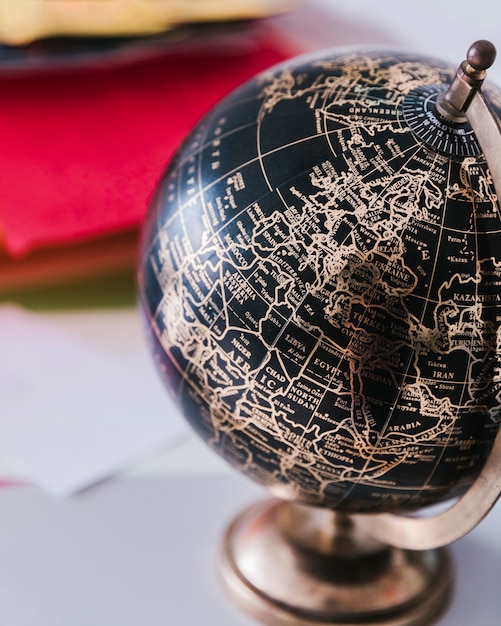 Free Photo decorative black and bronze globe on desk