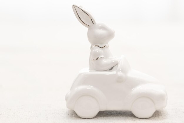 Decorative ceramic hare rides a car closeup