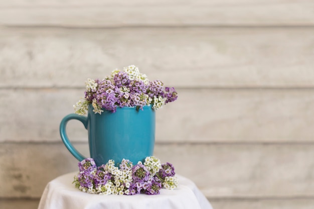 Free photo decorative composition with mug and flowers