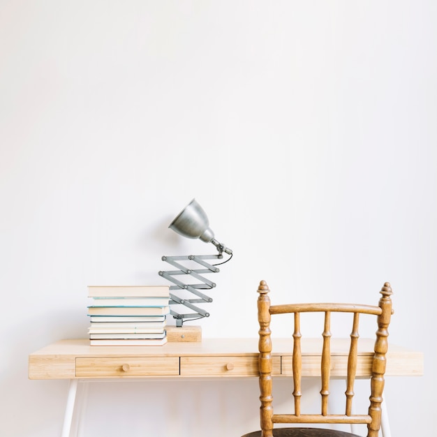 Free photo decorative desk with books and lamp