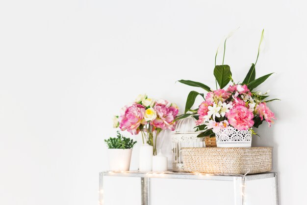 Decorative flowers on cabinet in front of wall