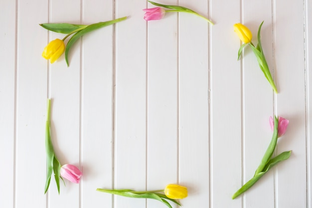 Decorative frame made of pink and yellow tulips