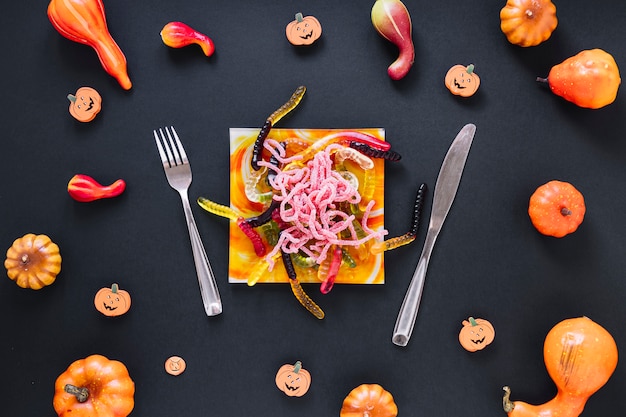 Decorative Halloween food surrounded by pumpkins