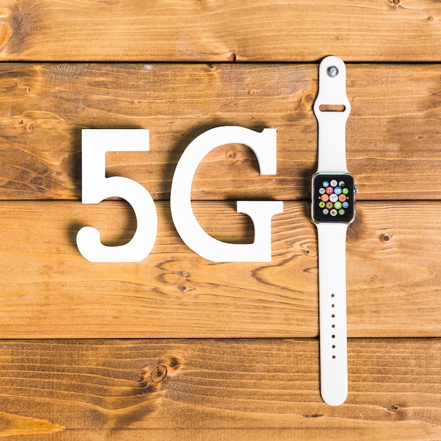 Free Photo decorative symbols 5g and smart watch on desk