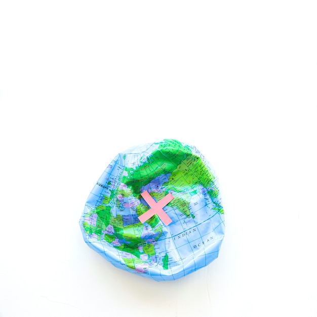 Deflated Earth ball and cross